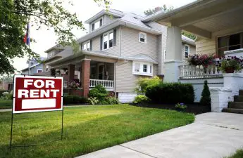 suburban-house-with-red-for-rent-sign-on-lawn