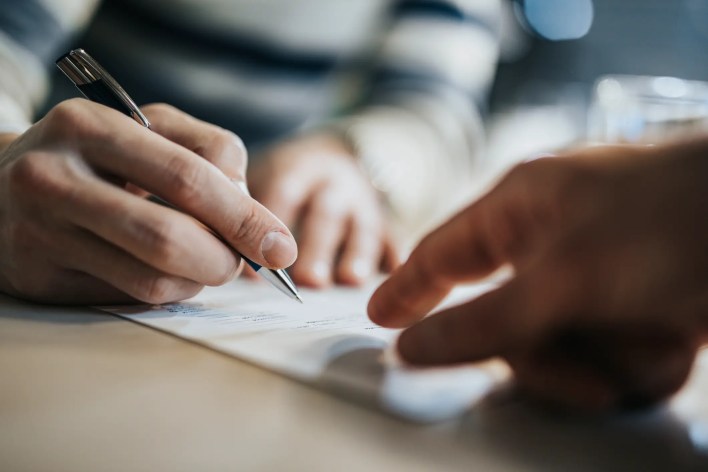 Signatory signing a lease agreement in the office of a landlord as opposed to signing a lease remotely.