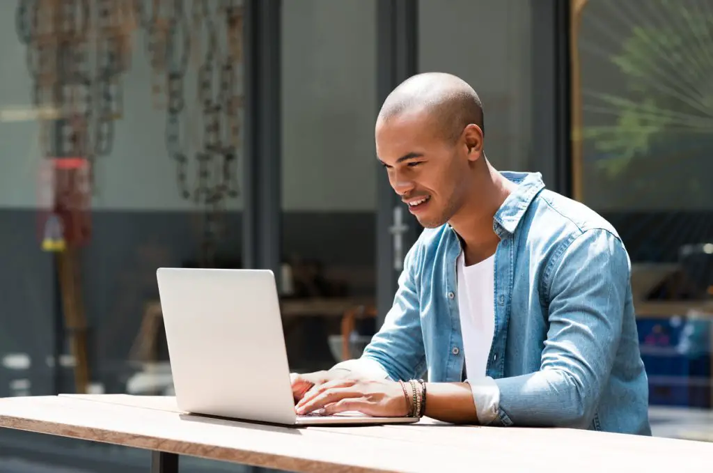 Young male tenant preparing to sign lease remotely on his laptop