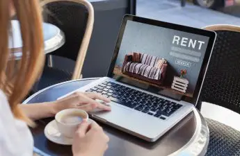 woman at laptop using top credit screening services for landlords